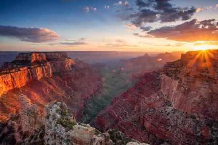 a canyon with a sunset in the background